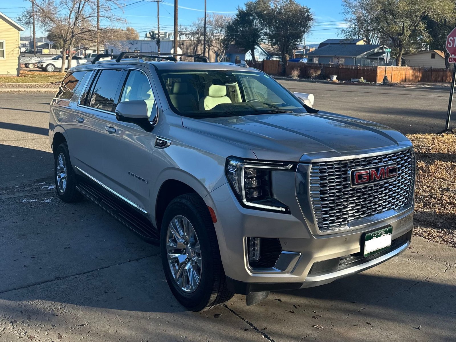 A GMC Yukon XL Denali on the road, showcasing the UVA and UVB rays protection provided by window tinting.